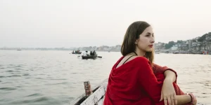 western-woman-boat-exploring-river-ganges